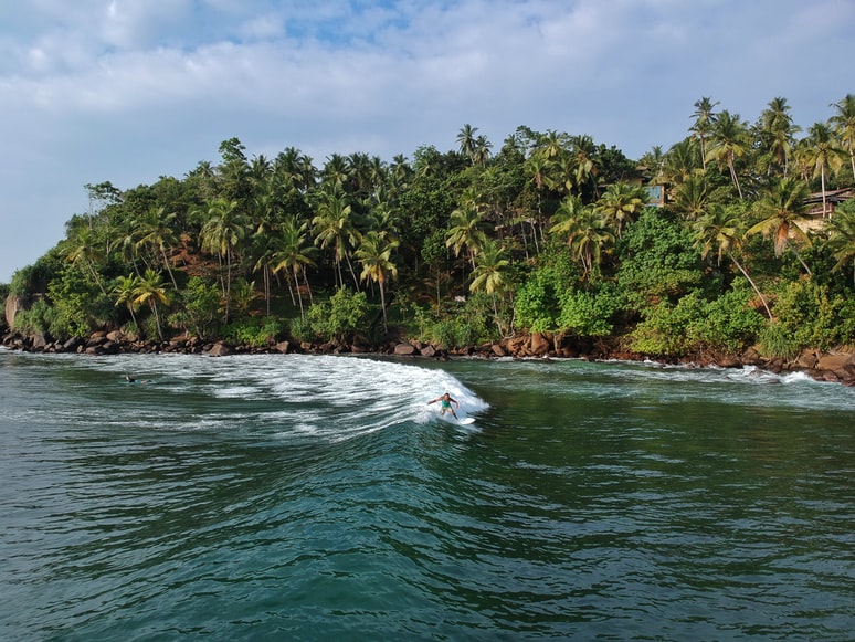 A surfer riding Mirissa's peeling waves in south Sri Lanka