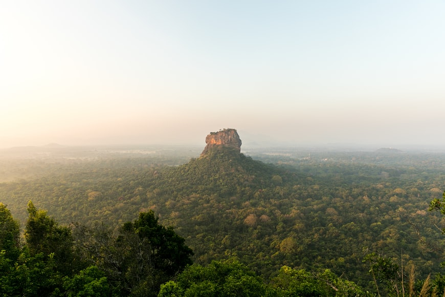 Sigiriya Rock just out of the skyline with this far away view of Sri Lanka's misty landscape